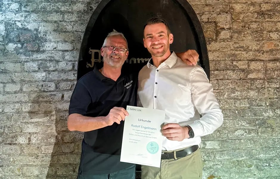 Matthias Herteux presents employee Rudolf Engelmann with a certificate to mark the company's 10th anniversary.
